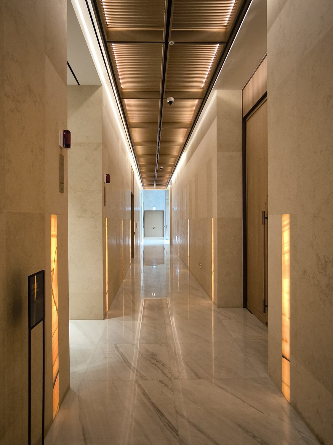 Onyx light along a marble corridor