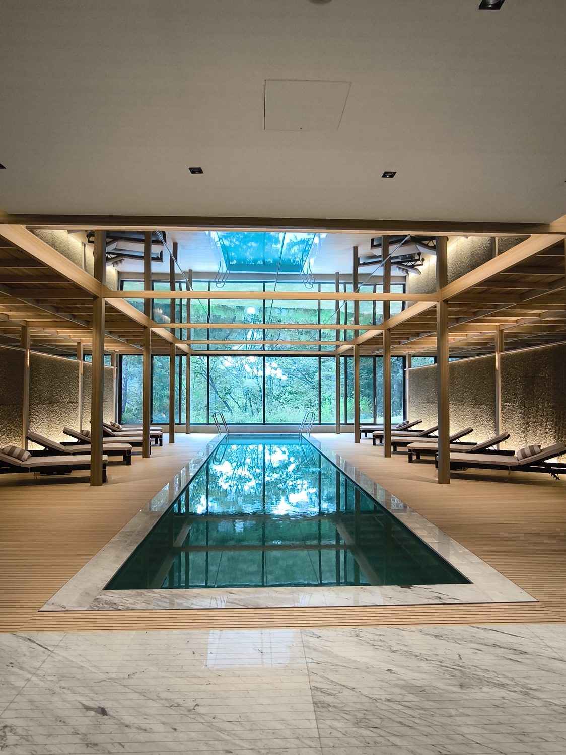 An indoor pool framed in timber and glass
