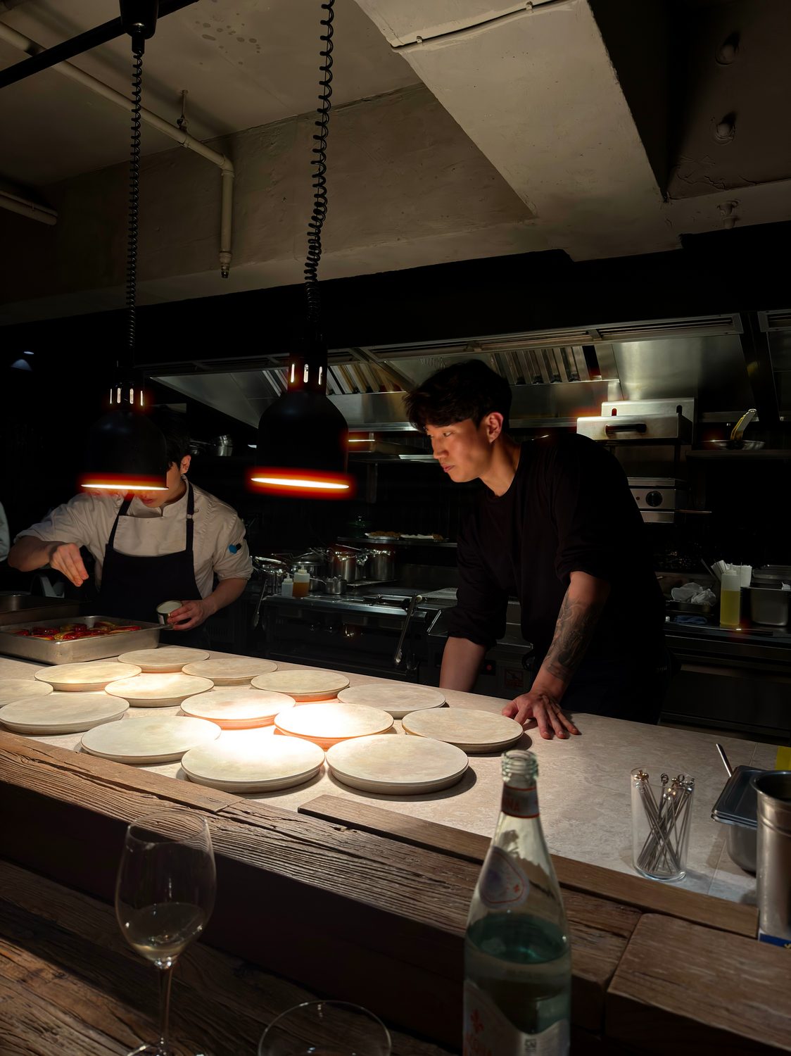 The open kitchen at ONYVA, plates warming under the lamps